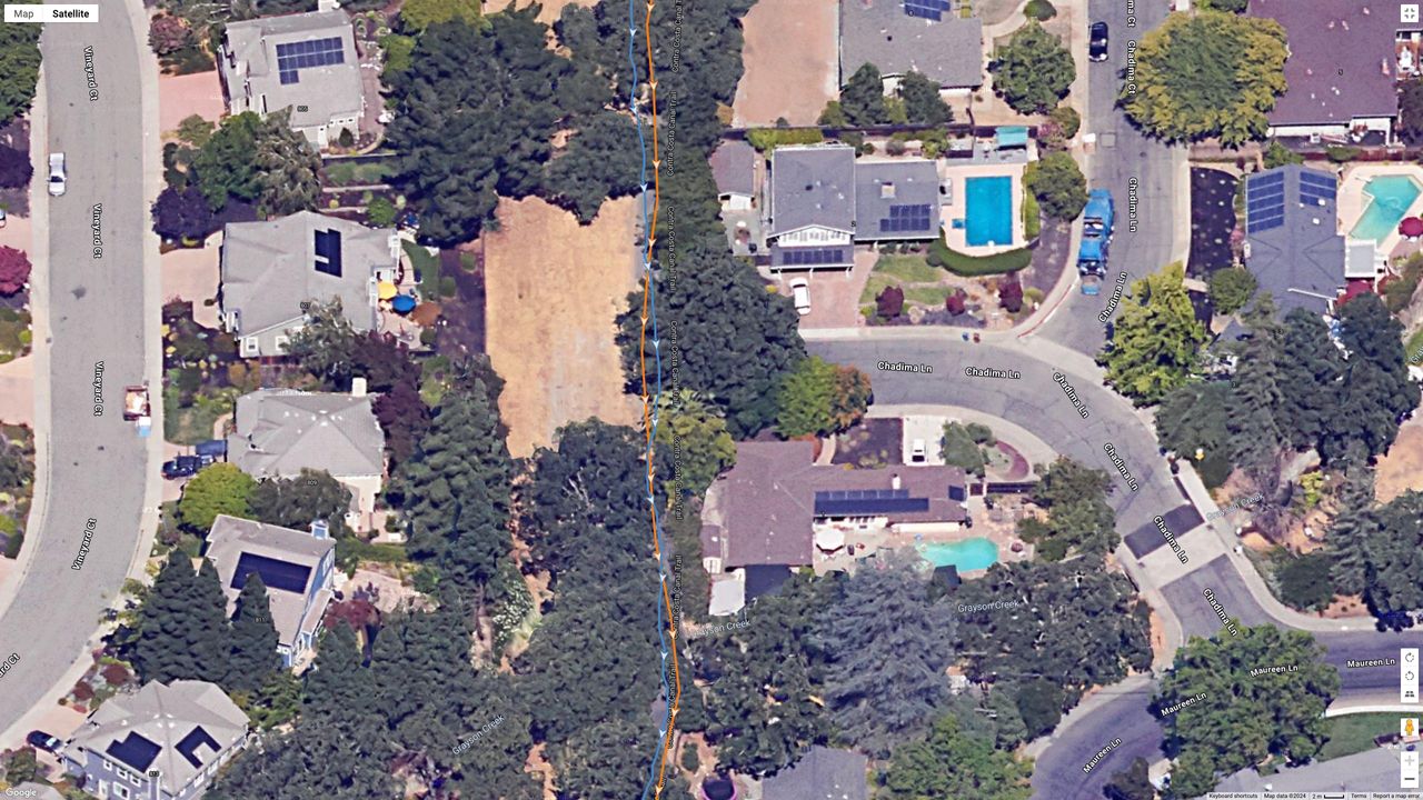 A Google Maps satellite view showing how the Polar Vantage M3 (blue line) and Garmin Fenix 8 (orange line) compared for GPS accuracy during a run.