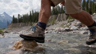 hiking boots walking through a stream