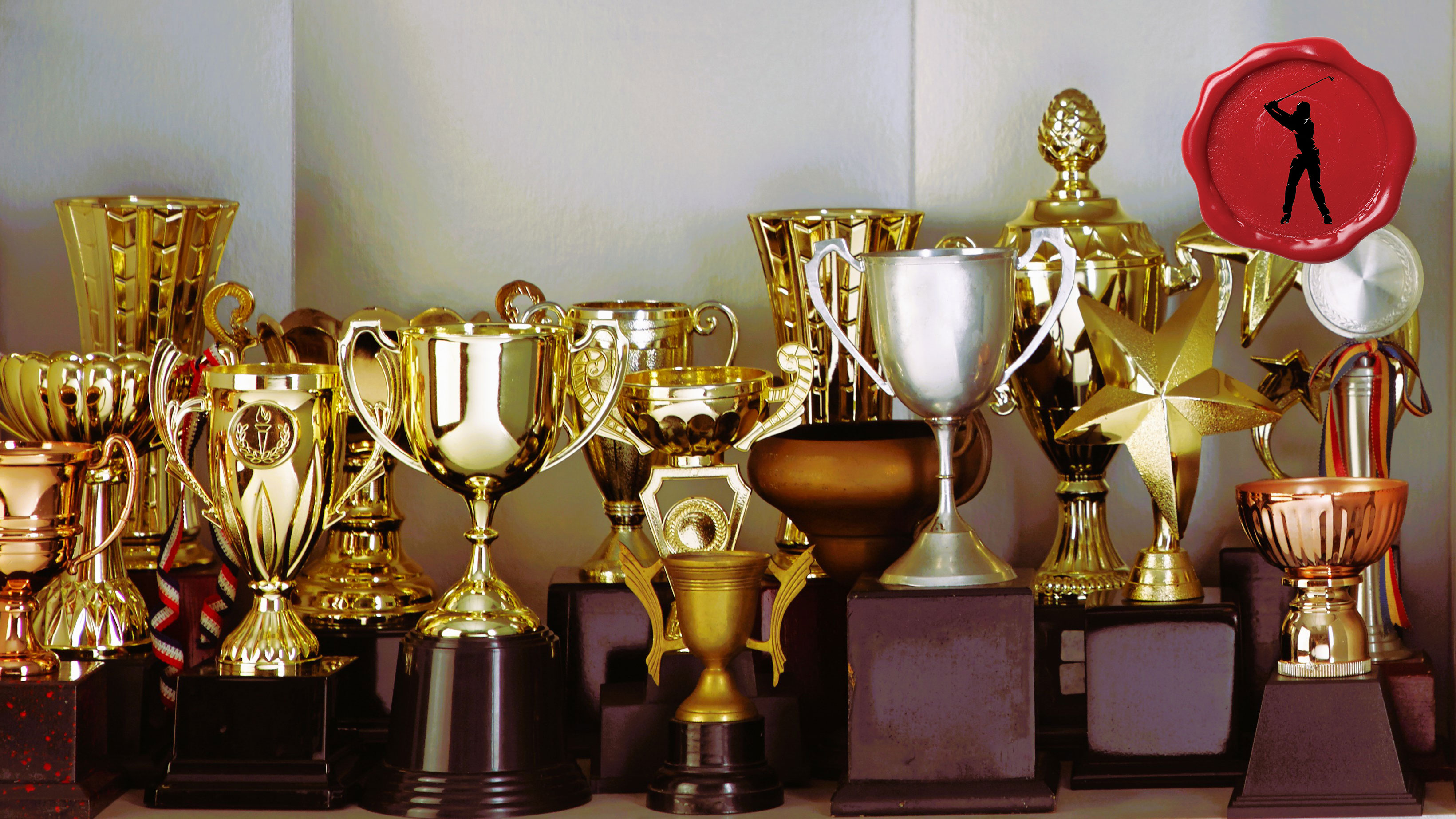 a collection of trophies in a cabinet with the seret club golfer stamp