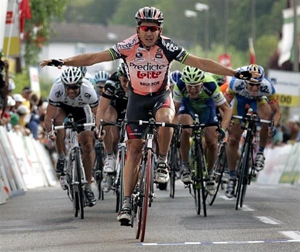 Robbie McEwen of Australia raises his arms on his way to win.