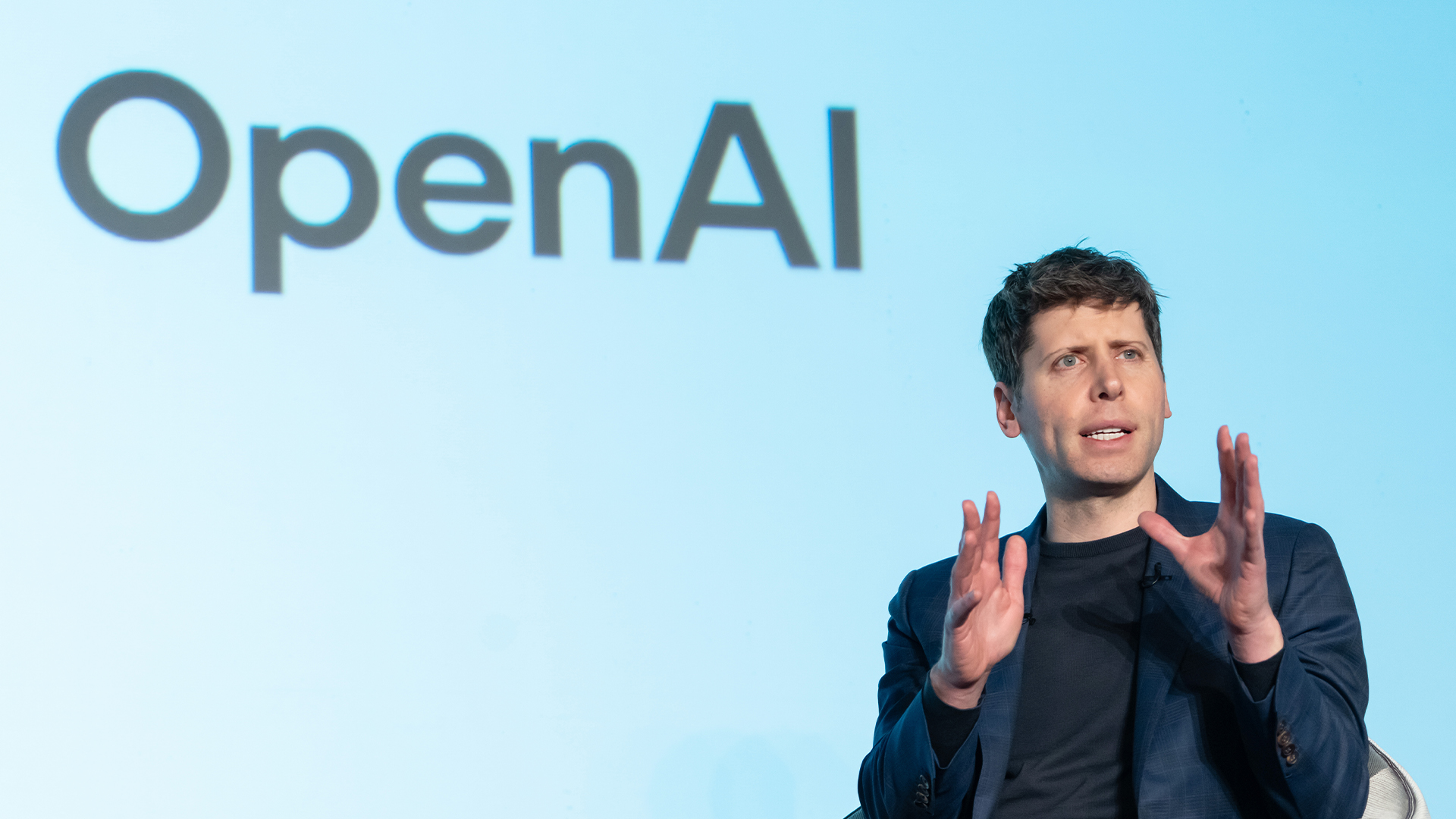 OpenAI CEO Sam Altman pictured speaking at an event titled "Transforming Business through AI" in Tokyo, Japan.