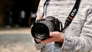 The Sony Alpha A9 II full-frame camera being hand held