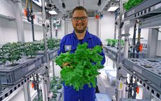 Paul Zabel holds veggies grown in the EDEN ISS greenhouse in Antarctica.
