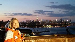 NASTAR space training center director Brienna Henwood, clad in a Final Frontier Design spacesuit, poses for photos with the New York City skyline as a backdrop during Final Frontier Design's Spacesuit Experience launch party on Aug. 28, 2014. The Brooklyn