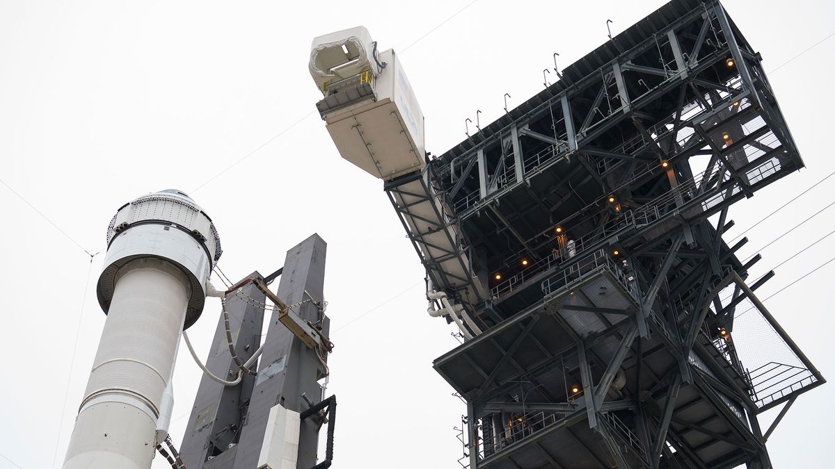 The crew access arm is seen as it swings into position for Boeing&rsquo;s CST-100 Starliner spacecraft atop a United Launch Alliance Atlas V rocket on the launch pad at Space Launch Complex 41 ahead of the Orbital Flight Test mission, Wednesday, Dec. 18, 2019 at Cape Canaveral Air Force Station in Florida.