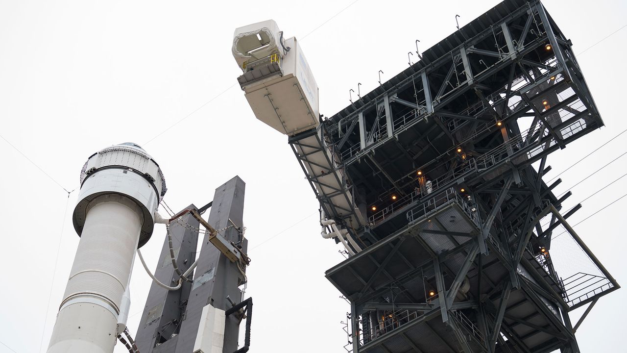 The crew access arm is seen as it swings into position for Boeing&rsquo;s CST-100 Starliner spacecraft atop a United Launch Alliance Atlas V rocket on the launch pad at Space Launch Complex 41 ahead of the Orbital Flight Test mission, Wednesday, Dec. 18, 2019 at Cape Canaveral Air Force Station in Florida.