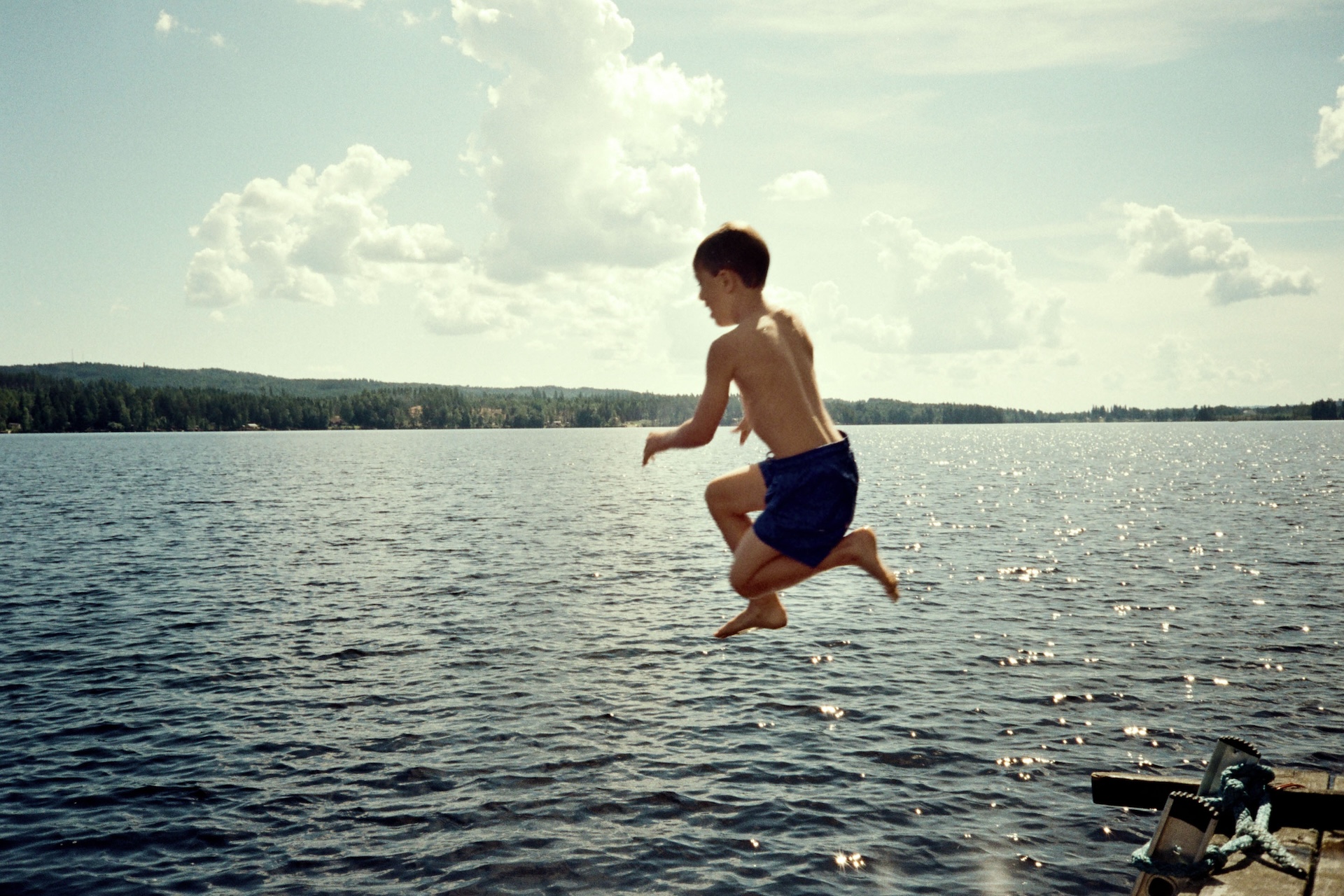 A boy cannonballs into a freshwater lake