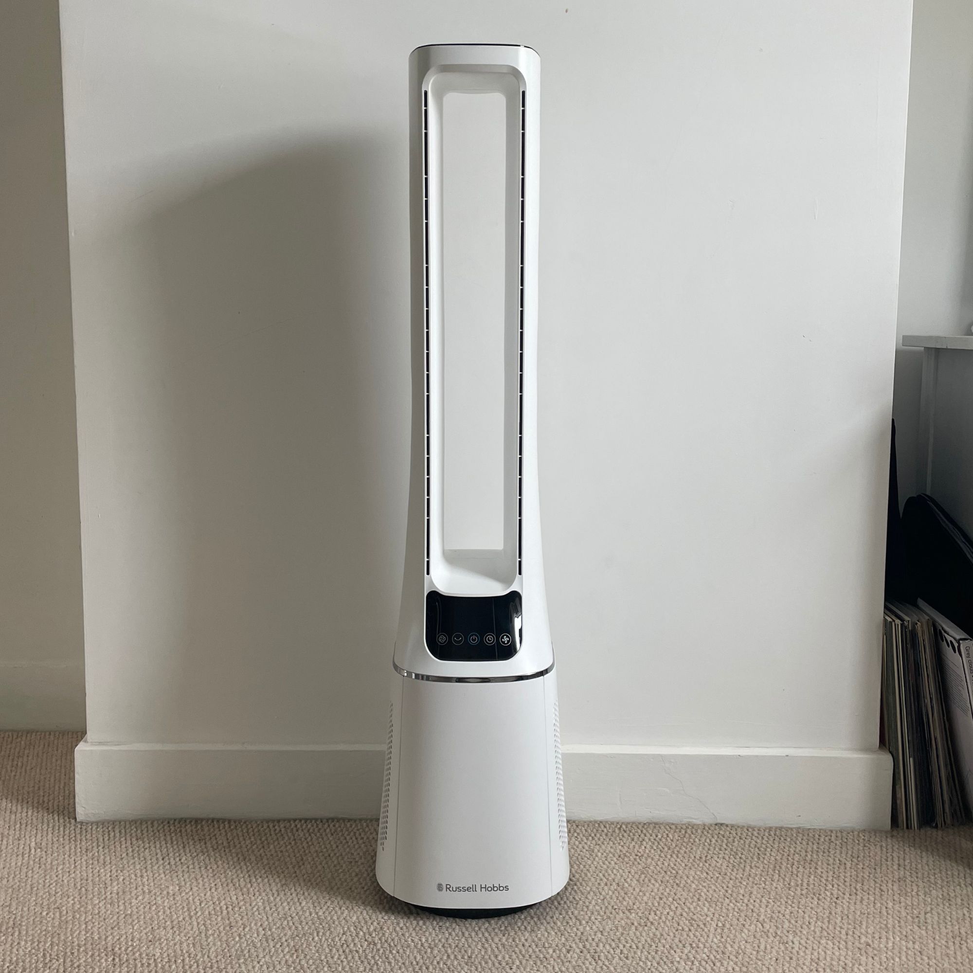 Russell Hobbs RHBLDL12 Bladeless Tower Fan standing in front of a white wall