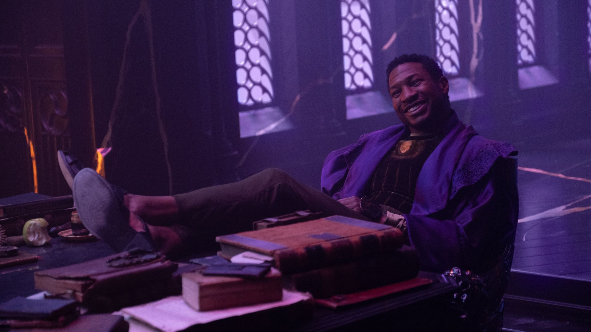 He Who Remains smiles as he puts his feet on a table in Loki episode 6
