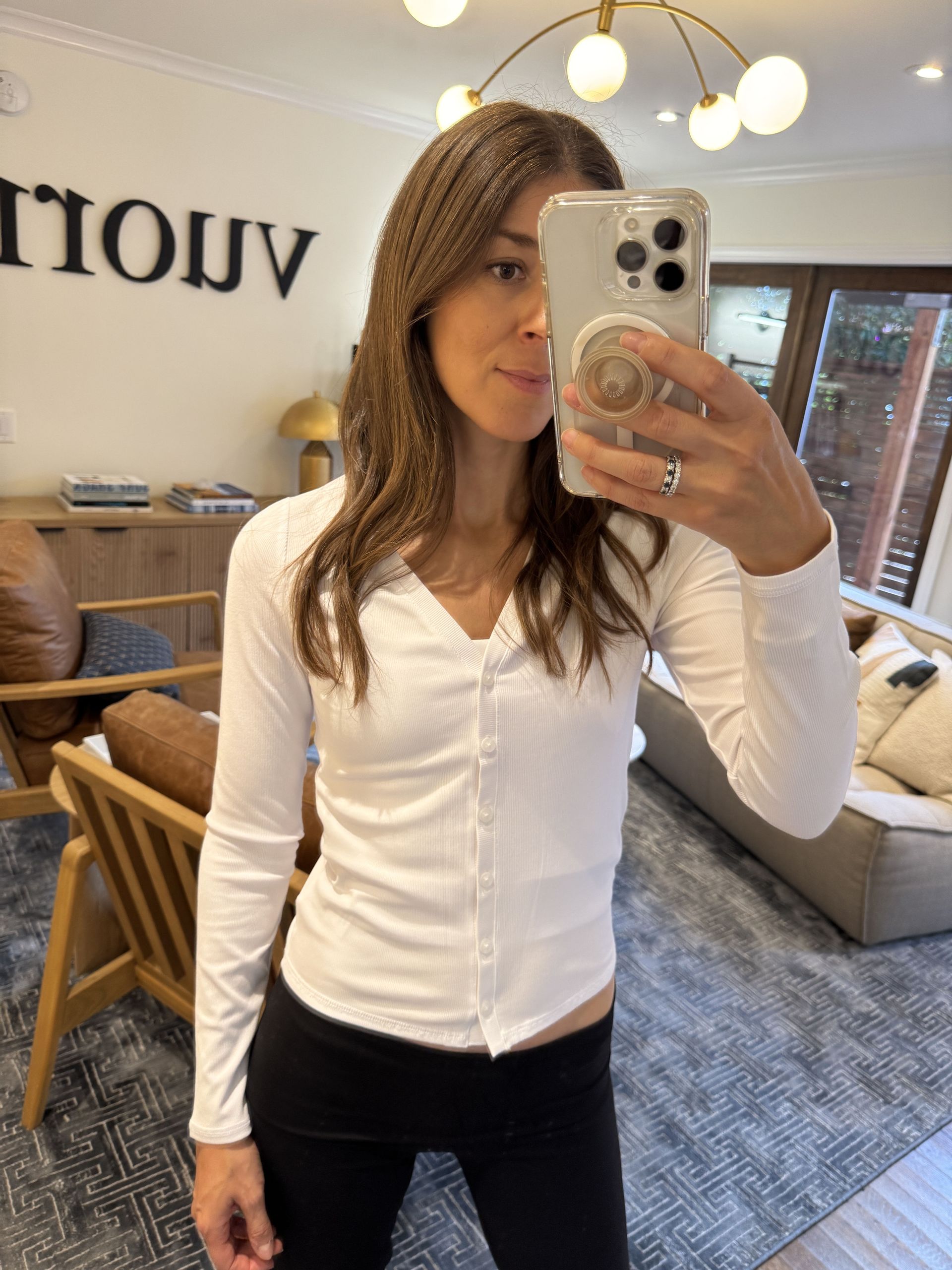 Woman in white top and black pants.