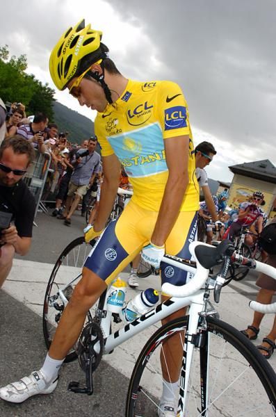 Contador checks the pressure on his back tire prior to the start.