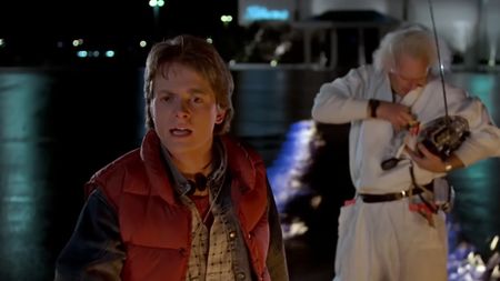 Michael J. Fox in the foreground looking stunned, with Christopher Lloyd in the background in Back to the Future. 