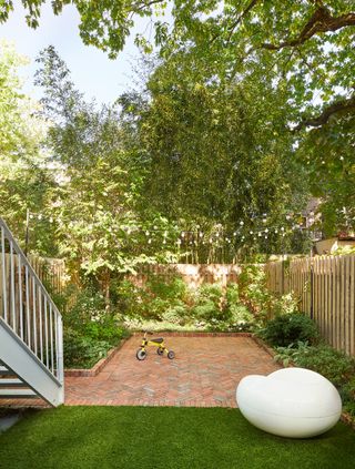 a small paved patio in a backyard