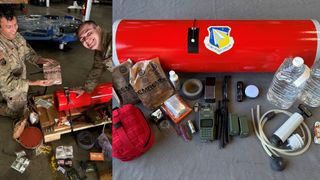 military people smile next to recovered cargo supplies.