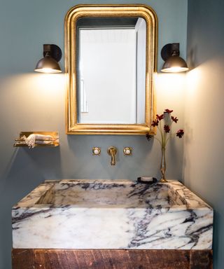 A small bathroom with a statement marble sink