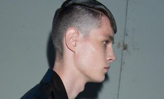 juxtaposing military-style shaved sides with hair
