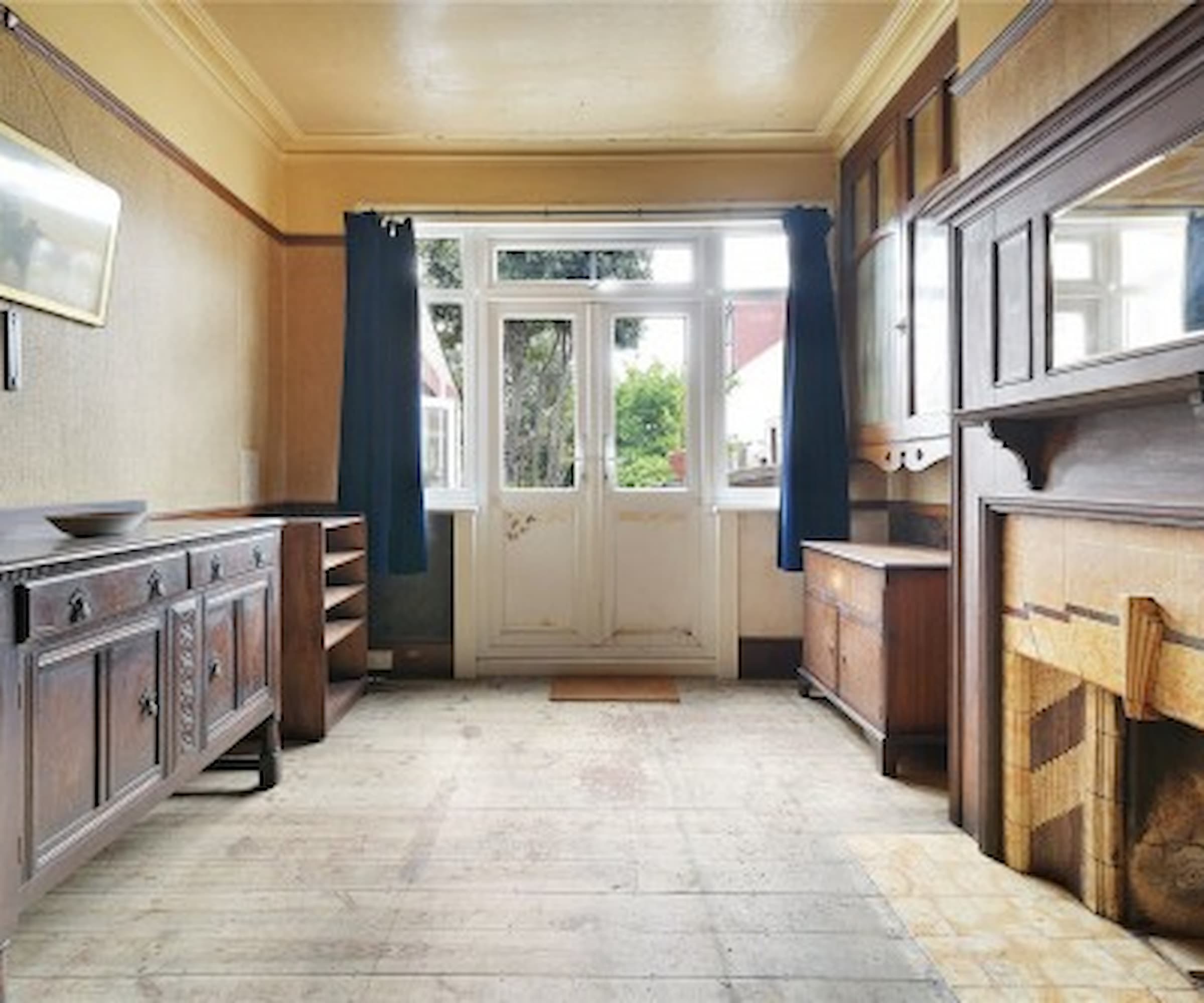 An entrance room with wooden flooring and a fireplace