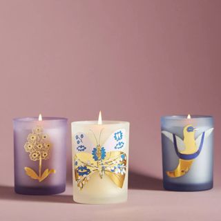 Trio of assorted pretty gift candles in decorative jar votives