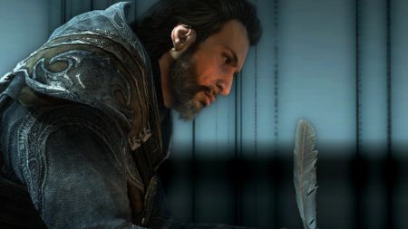 Best Assassin's Creed protagonists: Ezio Auditore sitting in a dark room writing with a quill. 