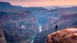 Man standing at the edge of the Grand Canyon, USA