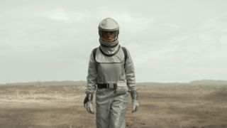 Juliette Nichols wearing a spacesuit and walking across an arid plain in Silo season 2