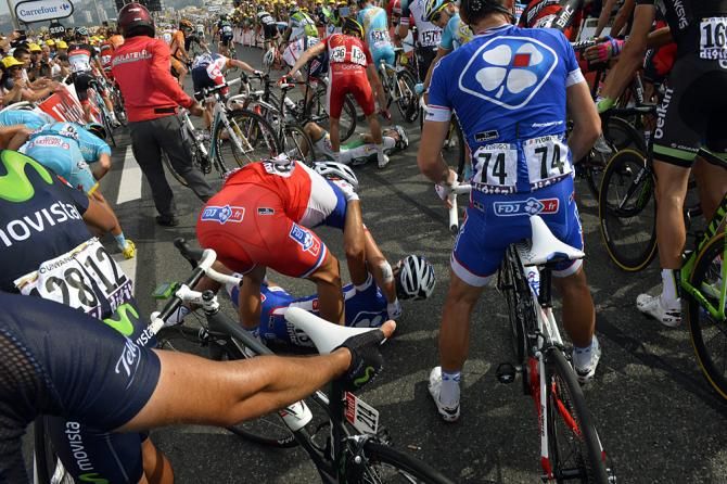 French champion Thibaut Pinot checks on his teammate