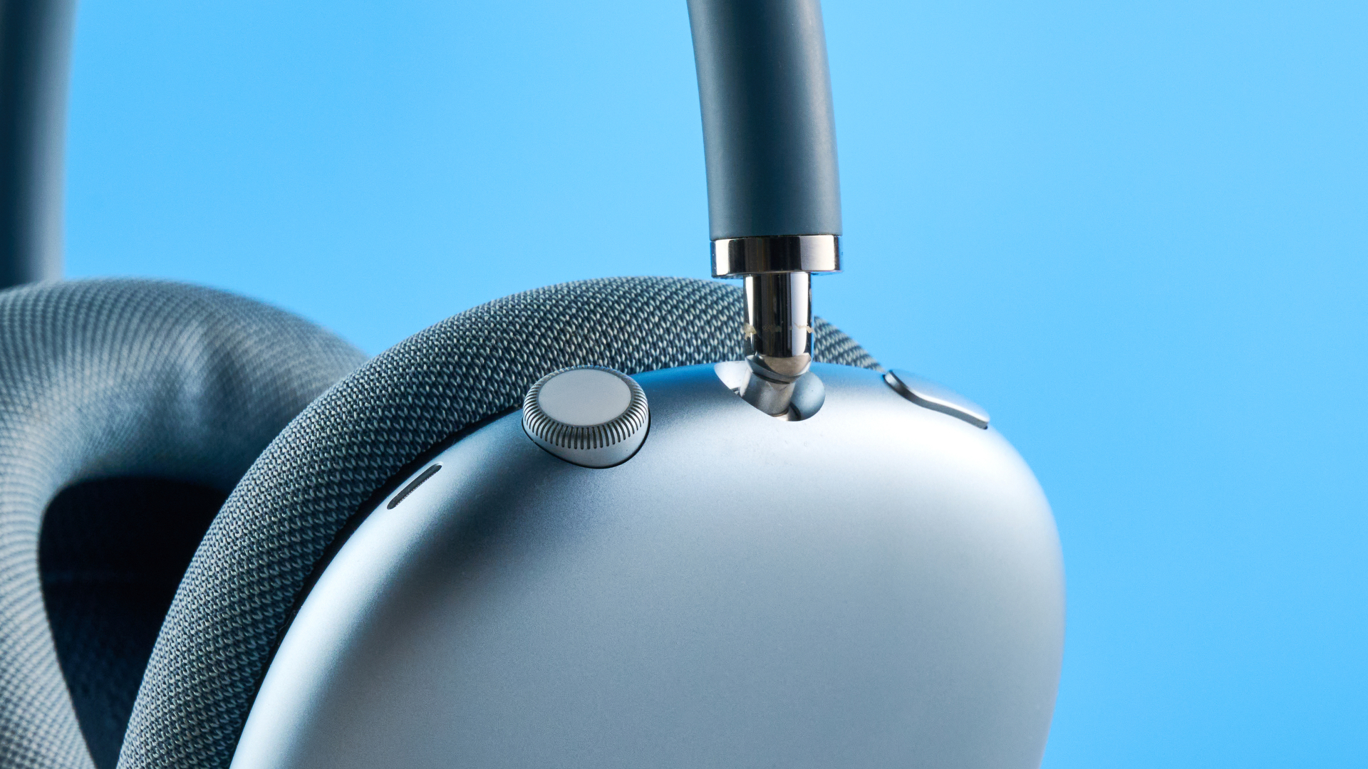 the airpods max (2024 edition) in blue photographed against the blue tom's guide background