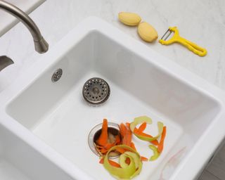 White sink with vegetable scraps