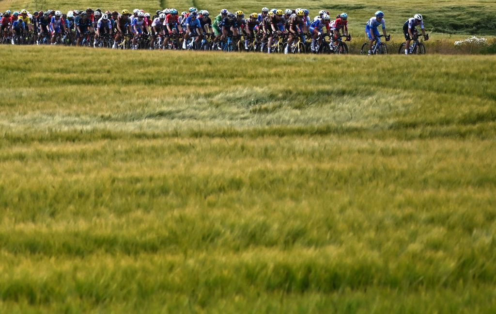 The pack of riders cycles past fields during the 2nd stage of the 109th edition of the Tour de France cycling race 2022 km between Roskilde and Nyborg in Denmark on July 2 2022 Photo by AnneChristine POUJOULAT AFP Photo by ANNECHRISTINE POUJOULATAFP via Getty Images