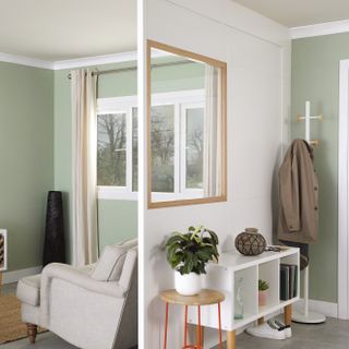 green living room and hallway divided using a partition with internal window