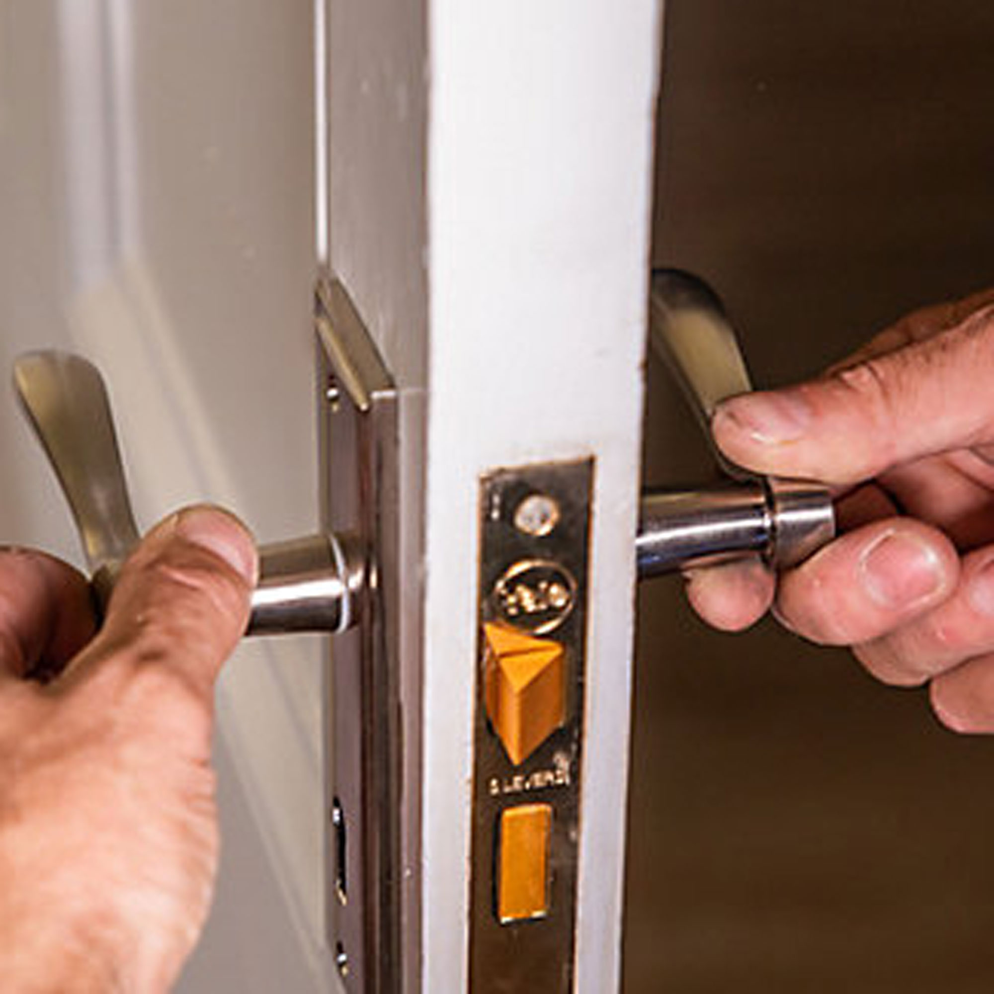 replacing an old door handle with a new one