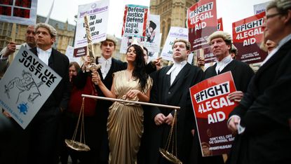 Protesters march against legal aid cuts in 2014
