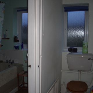 bathroom with toilet seat and window
