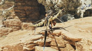 A bow-wielding hunter stands on a cliff in Monster Hunter Wilds.