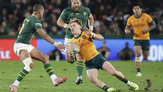 Australia's loose forward Nick Champion de Crespigny (C) slips as he runs with the ball during the Rugby Championship first round Test match between South Africa and Australia at the Ellis Park Stadium in Johannesburg on August 16, 2025.