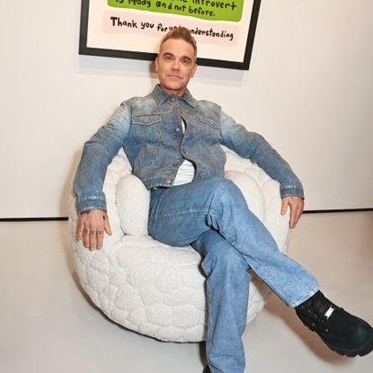 Robbie Williams sitting on his Introvert swivel chair created in collaboration with Moooi