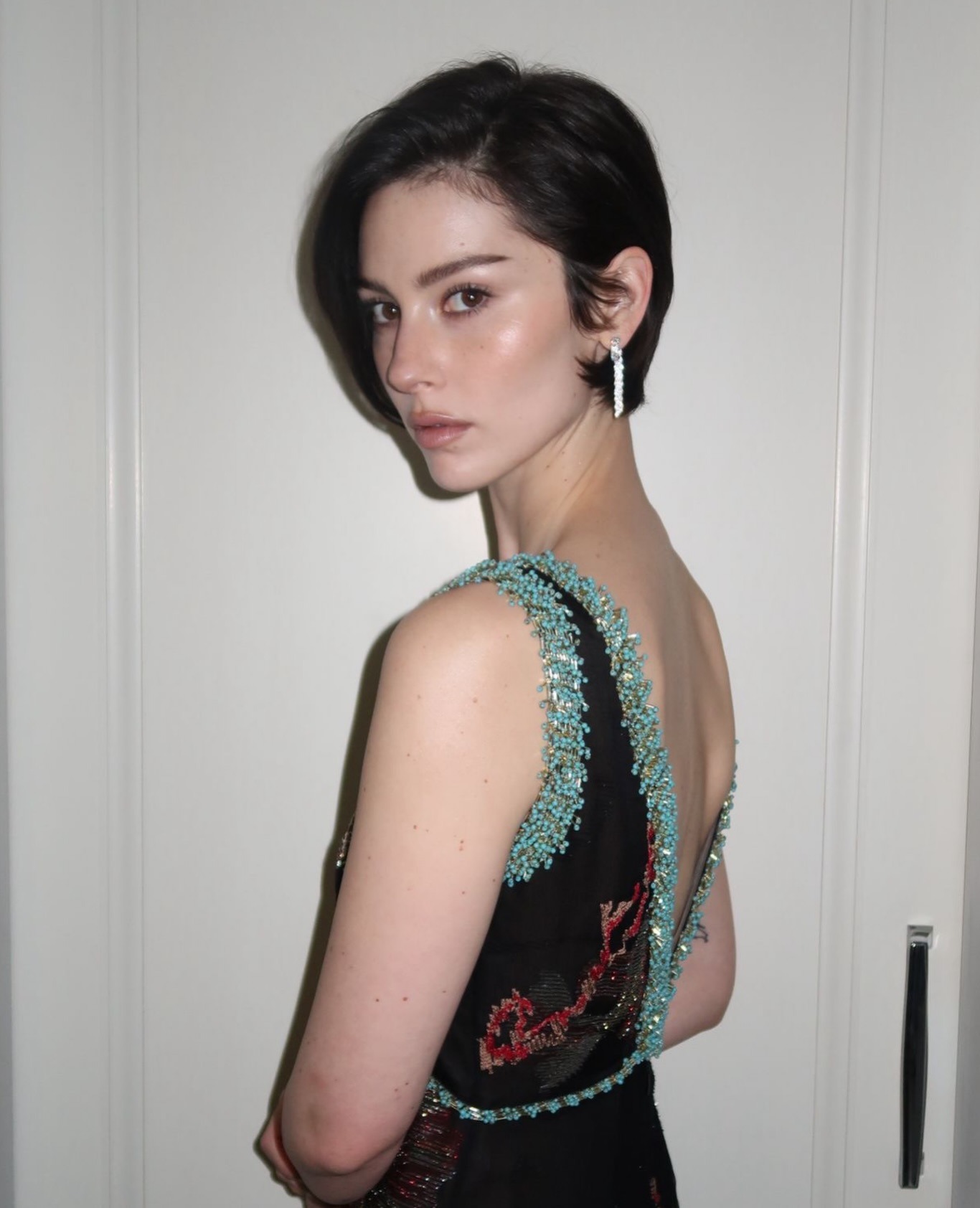 Gracie Abrams wearing a Chanel dress for the BAFTAs with a tucked pixie hairstyle