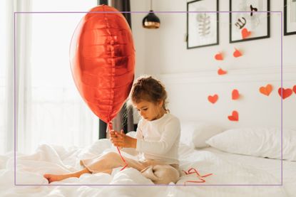 Valentines facts for kids illustrated by girl sat on white bed with hearts around her