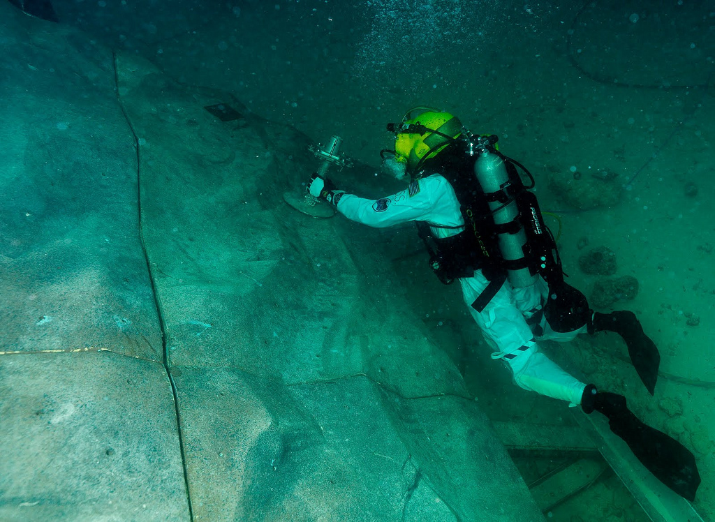 Steve Squyers maneuvers to an anchor point on &quot;asteroid&quot; rock wall during one of the extravehicular activities.