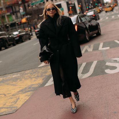 woman walking down street wearing zebra print shoes