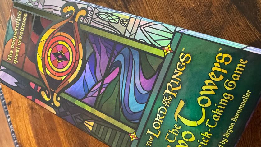 The Two Towers Trick-Taking Game box lying on a wooden surface