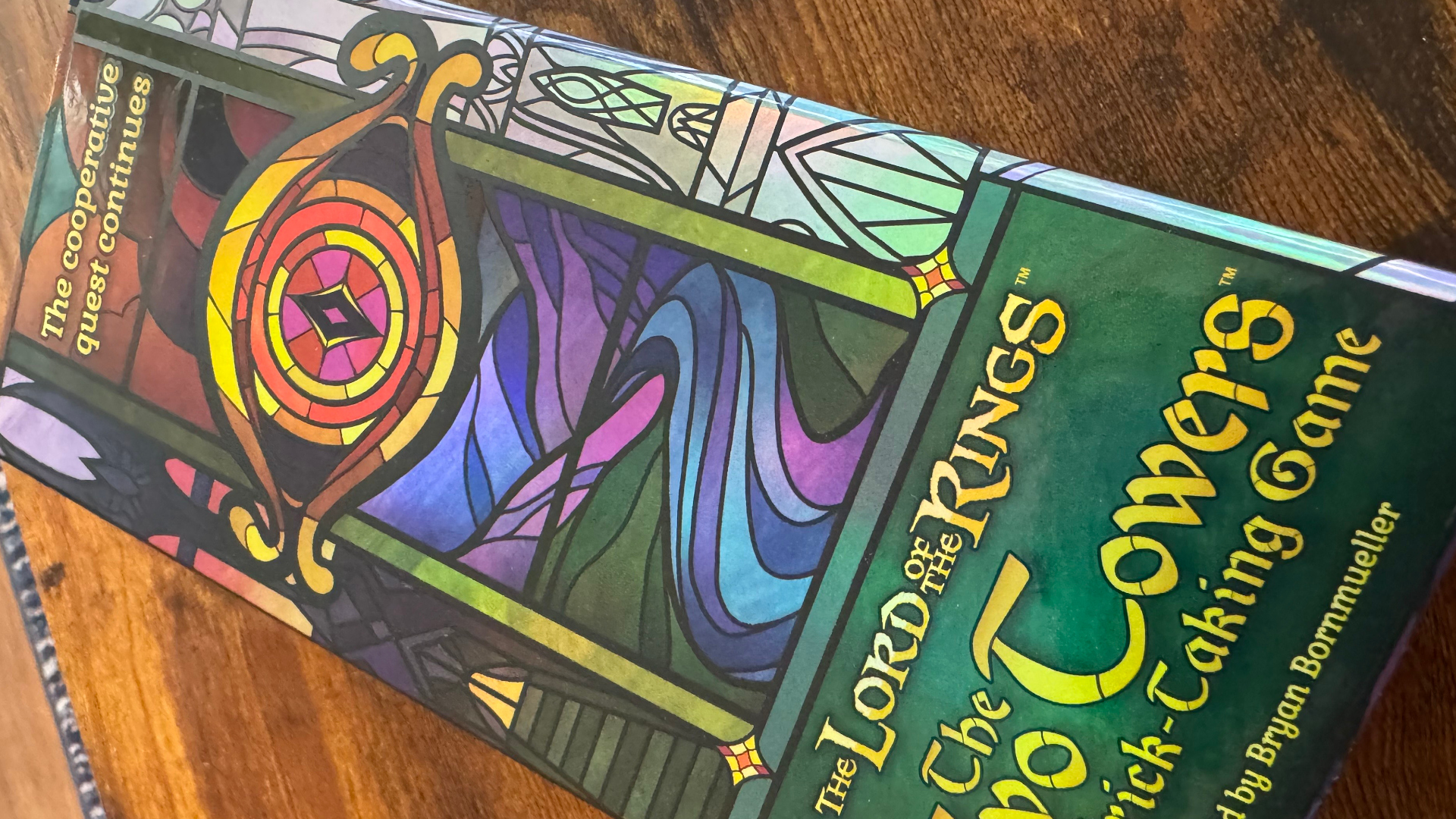 The Two Towers Trick-Taking Game box lying on a wooden surface