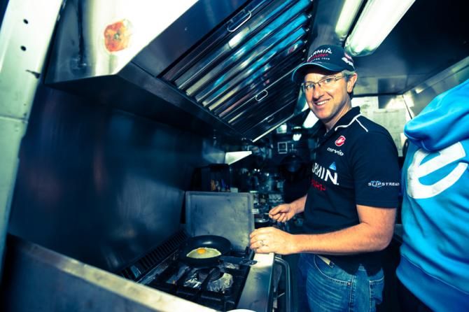Sean Fowler, team chef, starts cracking some eggs in the lorry/ kitchenette a far cry from his sleepy restaurant in northern Spain.