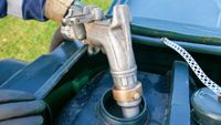 heating oil being pumped into tank in garden