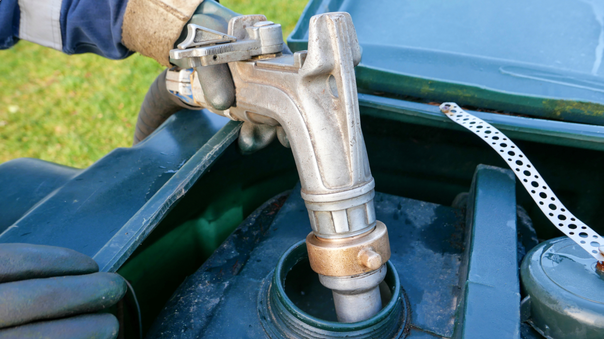 heating oil being pumped into tank in garden