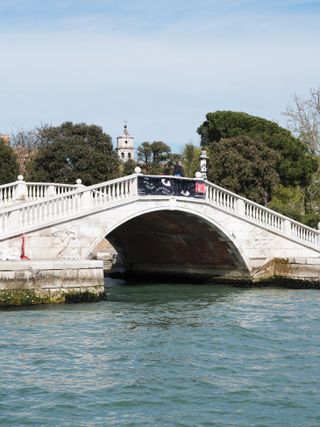 Banner for The Milk of Dreams biennale on Venice bridge