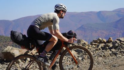 Cyclist riding with best bikepacking bags