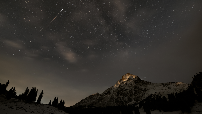 Shooting star above a snow mountain.