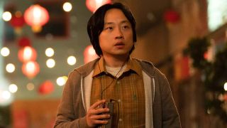 Jimmy O. Yang with a tape player in Interior Chinatown