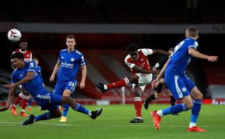 Bukayo Saka has a shot under pressure from multiple Leicester defenders
